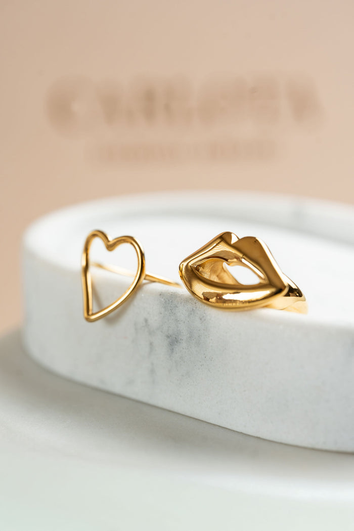 Anillos de acero dorado con forma de corazon y boca CARLOTA