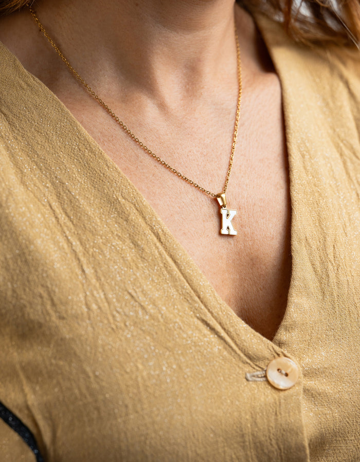 Collar de acero quirúrgico y baño de oro 18k con pendiente incial en modelo