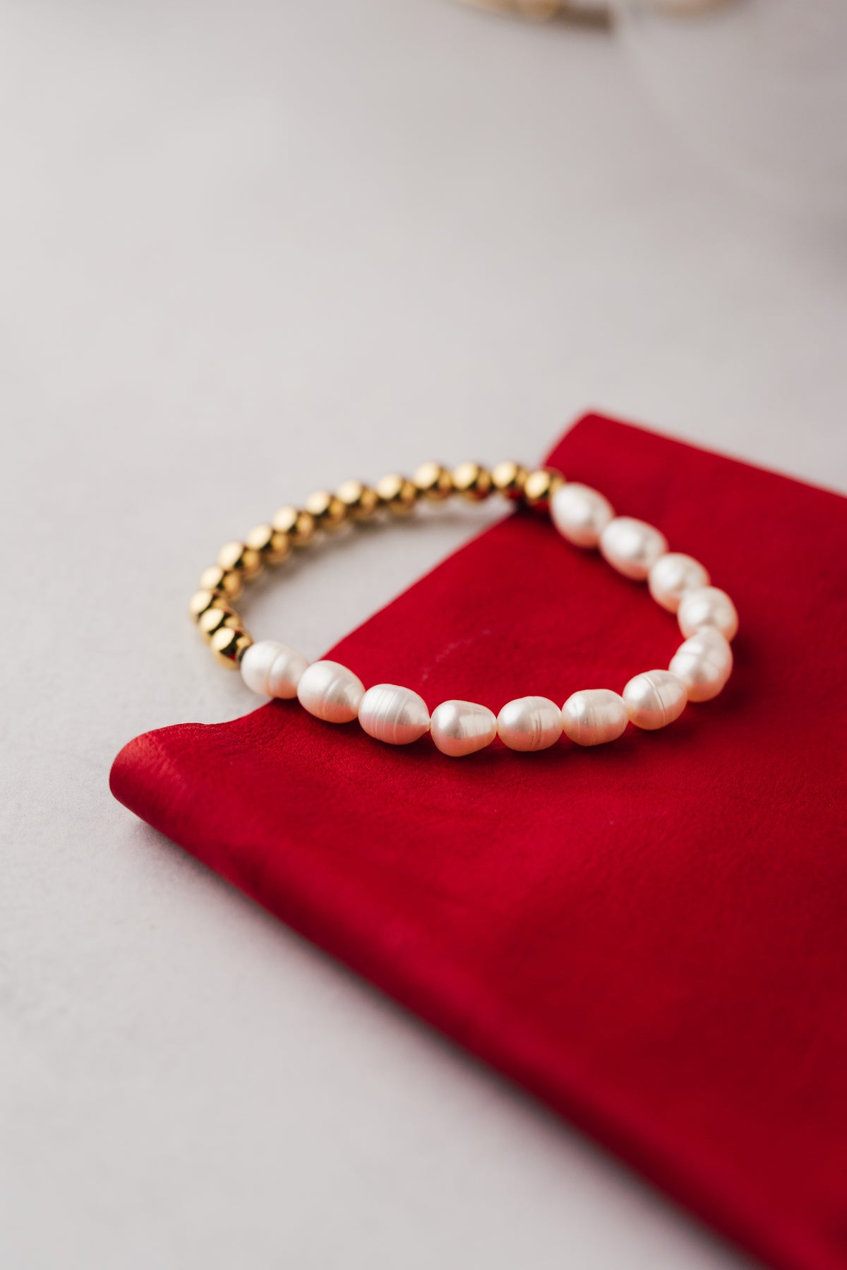 Pulsera en acero quirúrgico, baño de oro y perlas diseño minimalista y elegante.