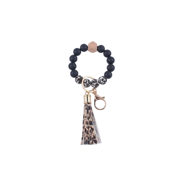 Llavero pulsera con cuentas negra y animal print y flecos colgantes en animal print en simil cuero

