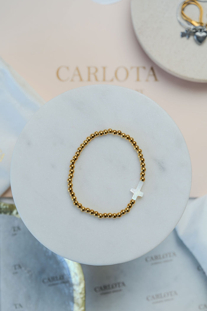 Pulsera de cuentas y cruz de acero dorado