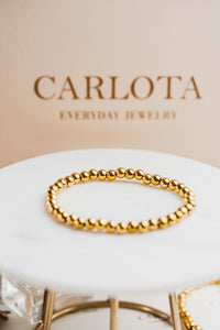 Pulsera elastizada de bolitas doradas en acero quirúrgico – CARLOTA.