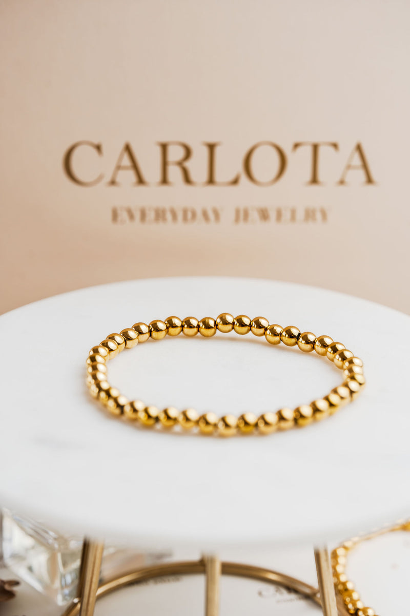 Pulsera elastizada de bolitas doradas en acero quirúrgico – CARLOTA.