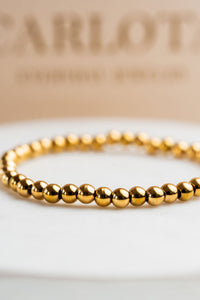 Pulsera elastizada de bolitas doradas en acero quirúrgico – CARLOTA.