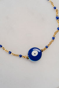 Pulsera de acero dorado y borlas azules con ojo turco